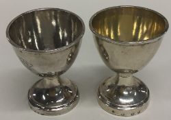 A pair of early Georgian silver egg cups of typica