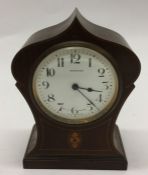 A small Edwardian mahogany mantle clock with white