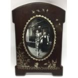 A large MOP and mahogany picture frame decorated i
