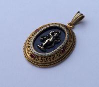 An Antique enamel and ruby pendant, the centre dec