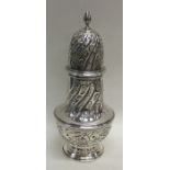 A tall silver swirl decorated sugar caster. London