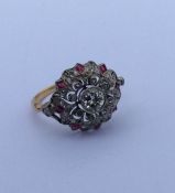 An attractive Edwardian diamond and ruby cluster r