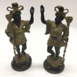 A pair of heavy brass mounted Blackamoor figures o