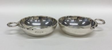 A heavy pair of cast silver wine tasters with text