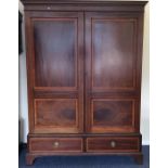 A late Victorian panelled wardrobe with drawers to