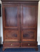 A late Victorian panelled wardrobe with drawers to