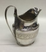 A Georgian silver bright cut cream jug with swirl