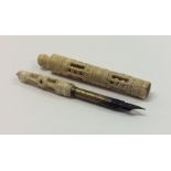 An Antique carved ivory quill with ball top. Est.