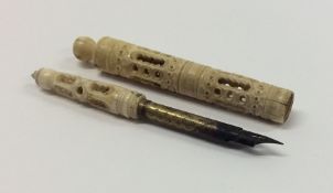 An Antique carved ivory quill with ball top. Est.