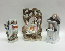 A group of three Staffordshire figures decorated w