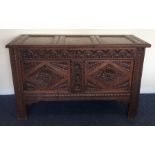 An Antique hinged top coffer with carved decoratio