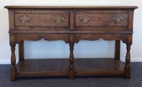 An oak two drawer Georgian style sideboard. Est. £