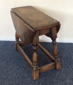 A small oak occasional table on stretcher base. Es