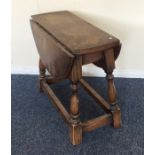 A small oak occasional table on stretcher base. Es