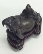 A bronze figure of an ox in recumbent position. Es