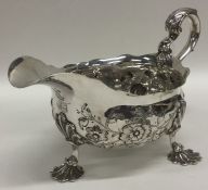 A Georgian silver sauce boat embossed with flowers