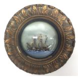 An unusual circular gilt framed model of The Golde