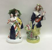 A pair of Staffordshire figures in blue ground. Ap