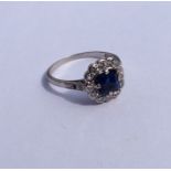 A sapphire and diamond cluster ring in platinum mo
