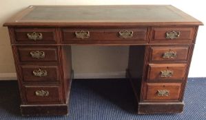 An Edwardian mahogany seven drawer twin pedestal d