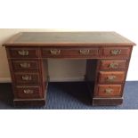 An Edwardian mahogany seven drawer twin pedestal d