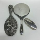 A silver embossed mirror together with one other a