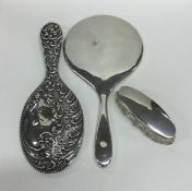 A silver embossed mirror together with one other a