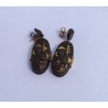 A pair of Shakudo oval earrings with gold mounts.