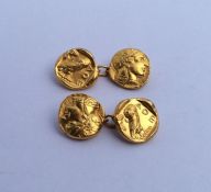 A pair of 18 carat cufflinks decorated with Greek