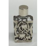 A small pierced silver perfume bottle decorated wi