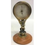 An unusual brass mounted barometer with silvered d