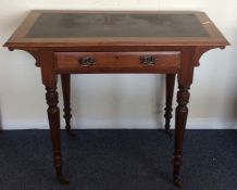 An Edwardian single drawer writing desk with leath