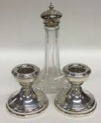 A pair of silver dwarf candlesticks together with