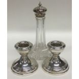 A pair of silver dwarf candlesticks together with