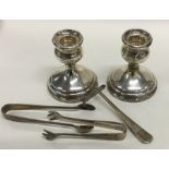 A pair of silver dwarf candlesticks together with
