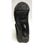 A carved Ethiopian hardwood figure of a monkey. Ap