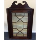 A Georgian mahogany corner cupboard with bevelled