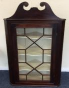 A Georgian mahogany corner cupboard with bevelled