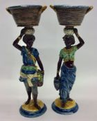 A pair of blue ground figures of ladies holding ba