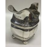 An Irish Georgian silver cream jug, the body decor