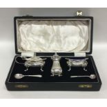 A boxed Adams' style silver three piece cruet toge