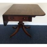 A Georgian mahogany two lap table on spreading sup