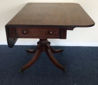 A Georgian mahogany two lap table on spreading sup