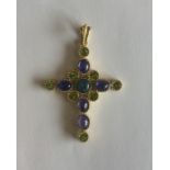 A large 18 carat gold cross decorated with peridot