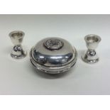 An unusual pair of travelling silver candlesticks