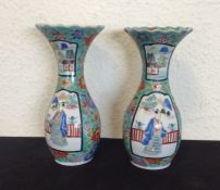 A pair of Chinese blue ground vases decorated with