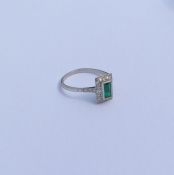 A good emerald and diamond rectangular cluster rin