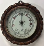 A carved oak aneroid barometer. Est. £20 - £30.