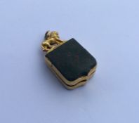 A bloodstone inset intaglio pendant with lion deco