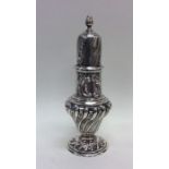 A tall silver swirl decorated sugar caster. London